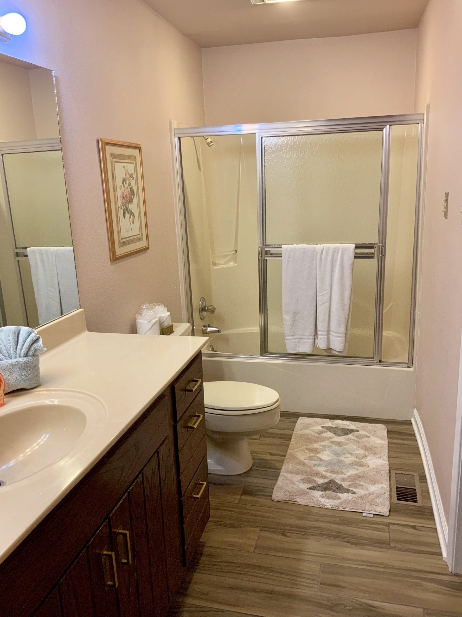 A bathroom with a sink , toilet , tub and shower.
