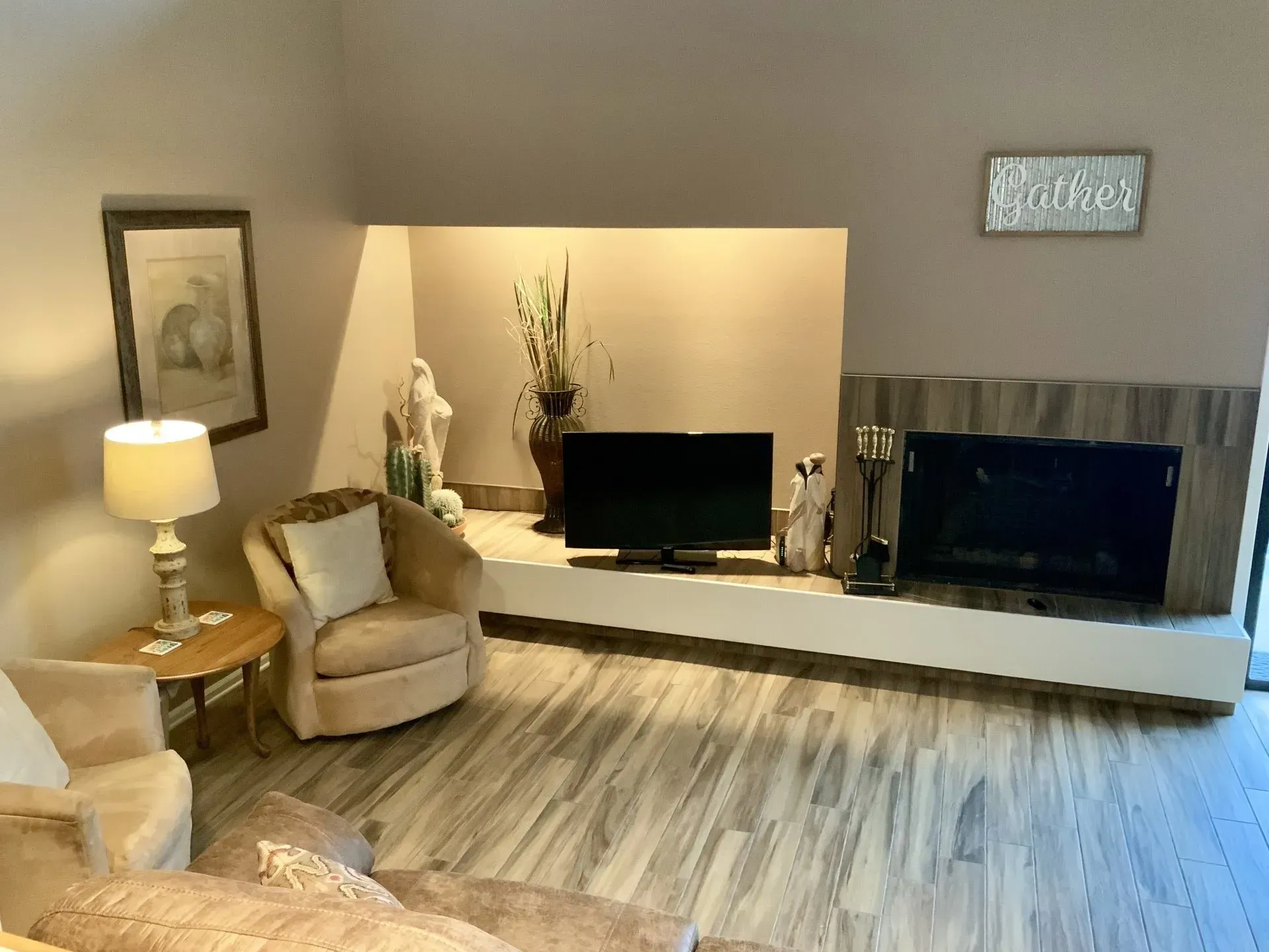 A living room with a fireplace and a flat screen tv.