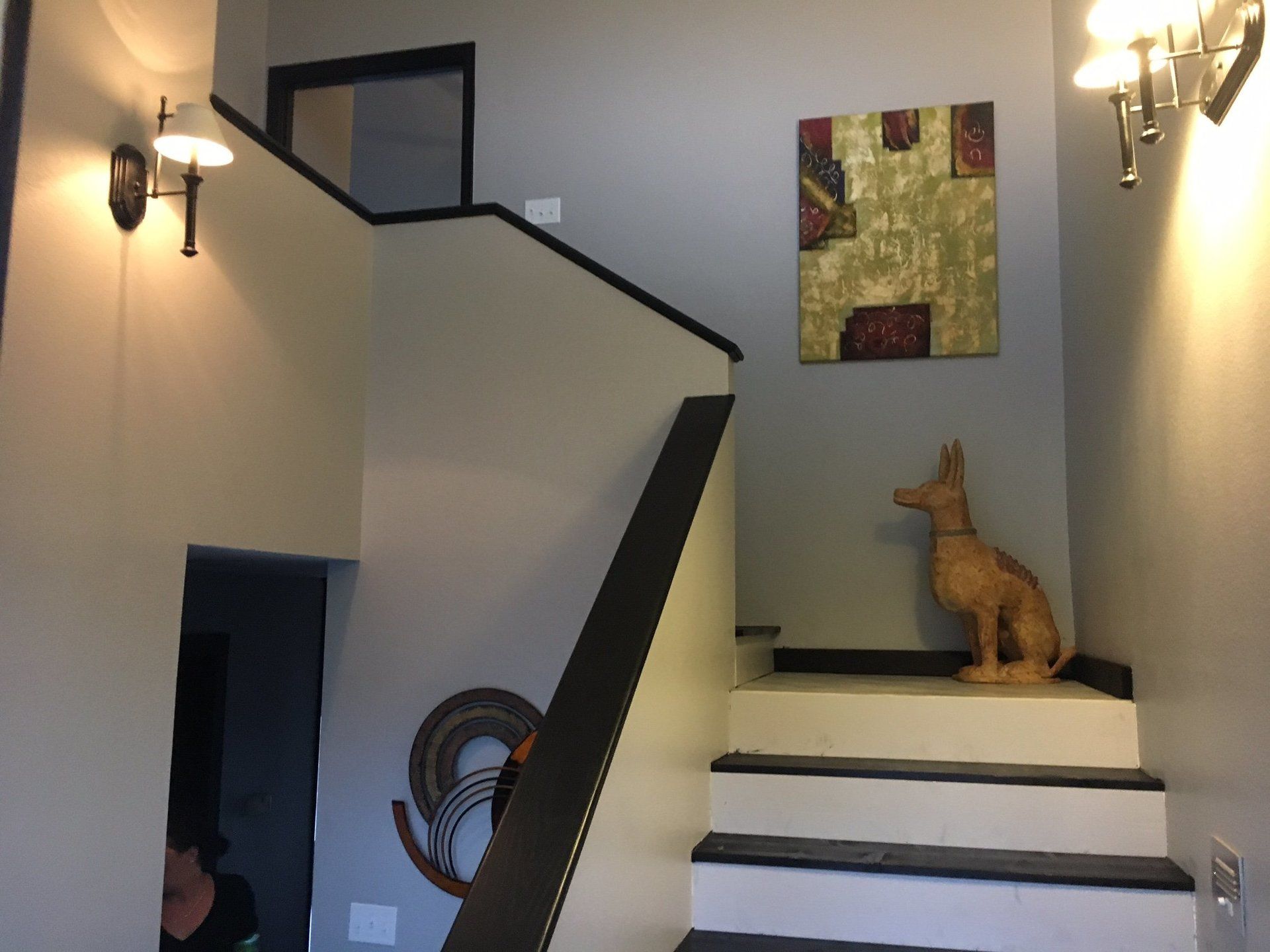 A staircase with a statue of a dog on it