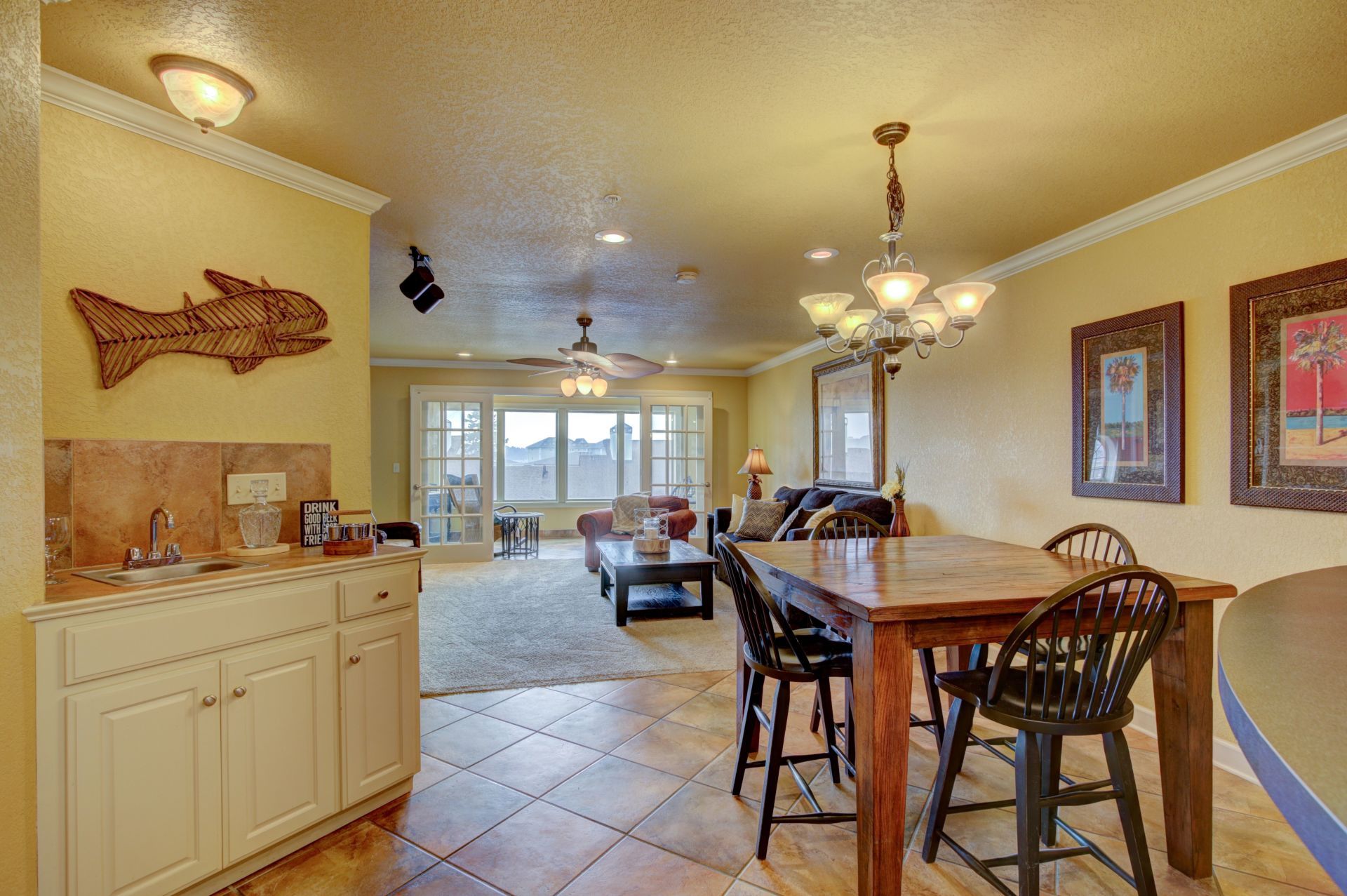 There is a table and chairs in the middle of the room.