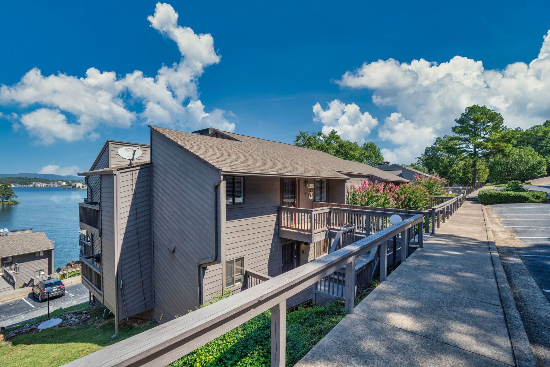 A large apartment building with a balcony overlooking a lake