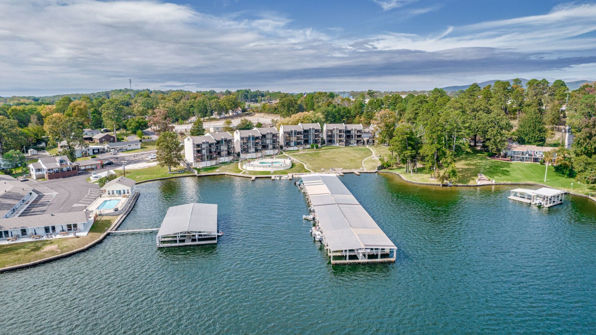 An aerial view of a large body of water with a dock in the middle of it.
