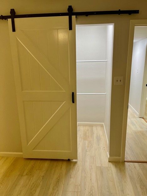 There is a sliding barn door in the middle of a room.