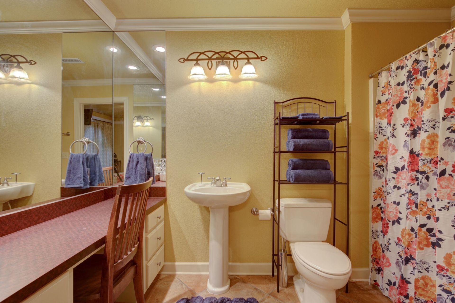 A bathroom with a toilet , sink and shower curtain
