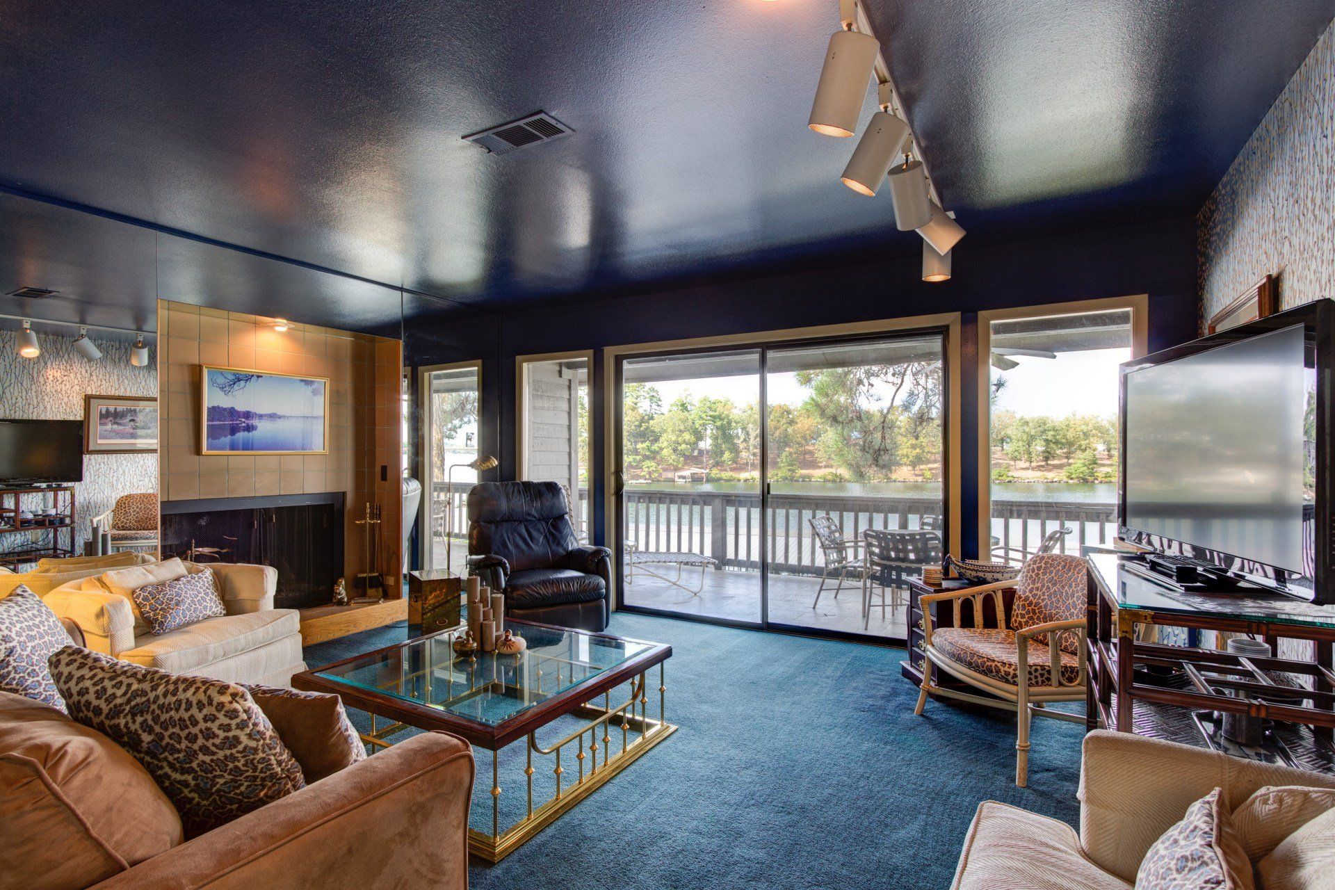A living room filled with furniture and a sliding glass door leading to a balcony.
