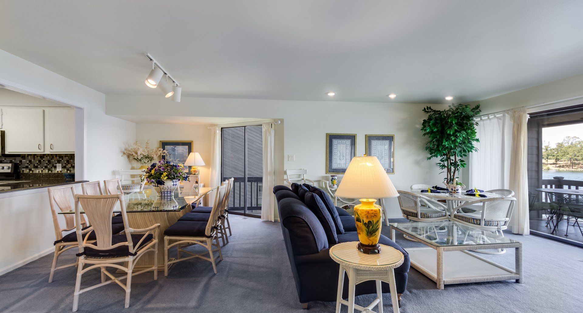 A living room with a couch , table , chairs and lamps