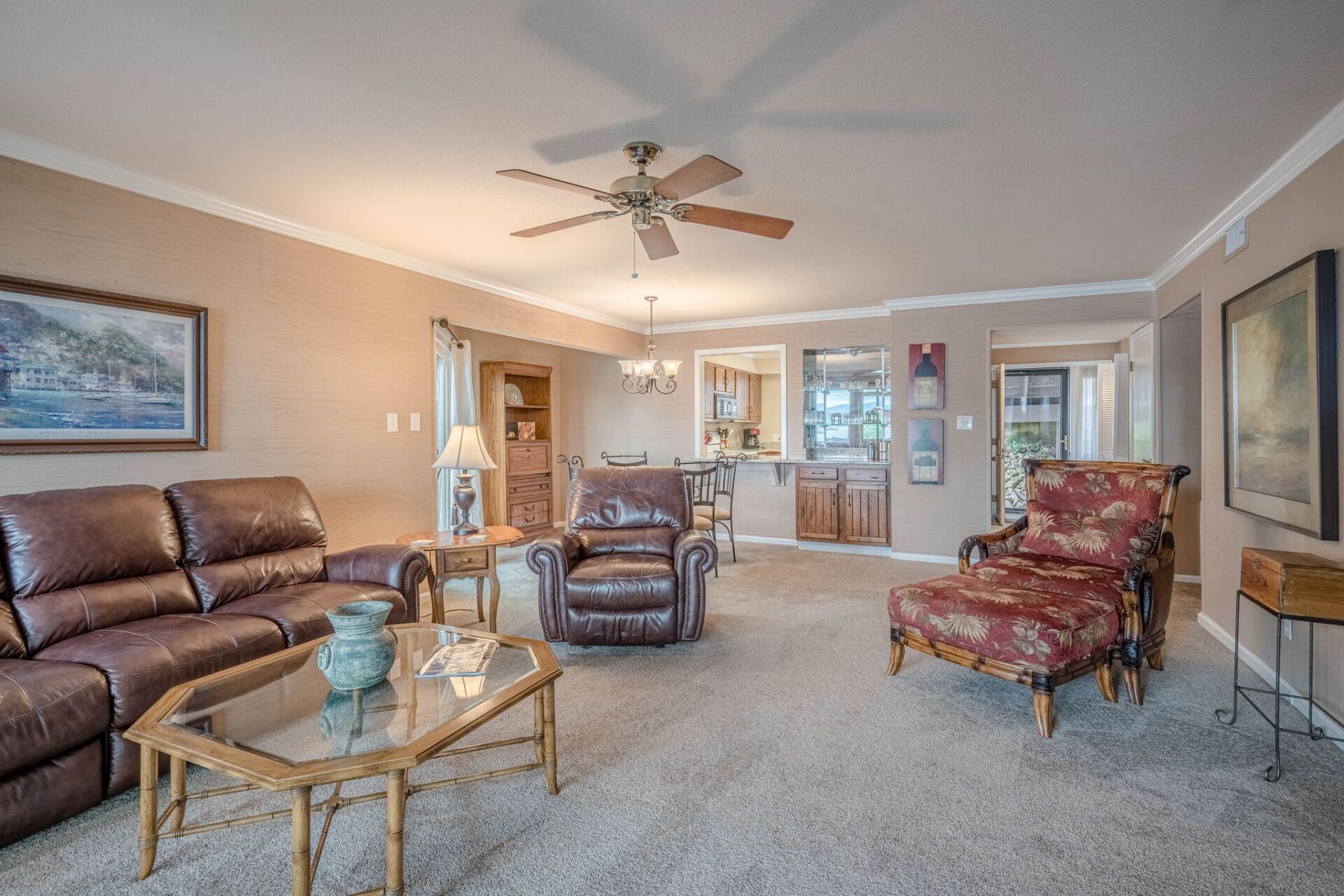 A living room filled with furniture and a ceiling fan.