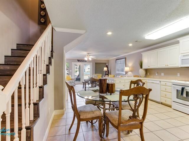 A kitchen with a table and chairs and stairs
