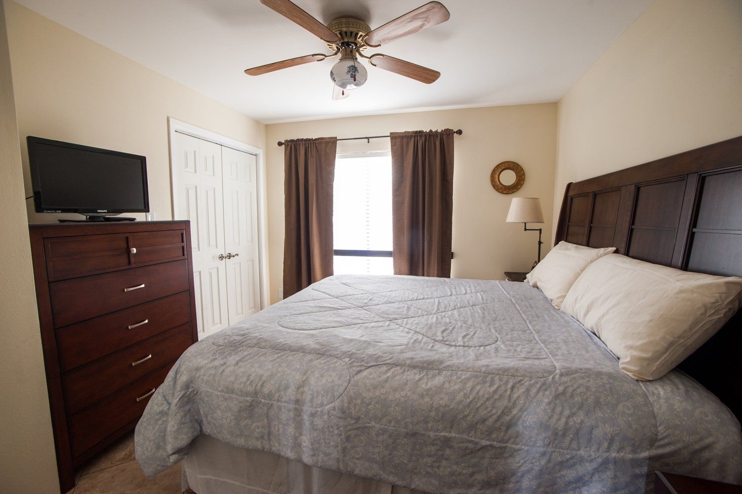 large bedroom with dresser and television at Willow Beach B1