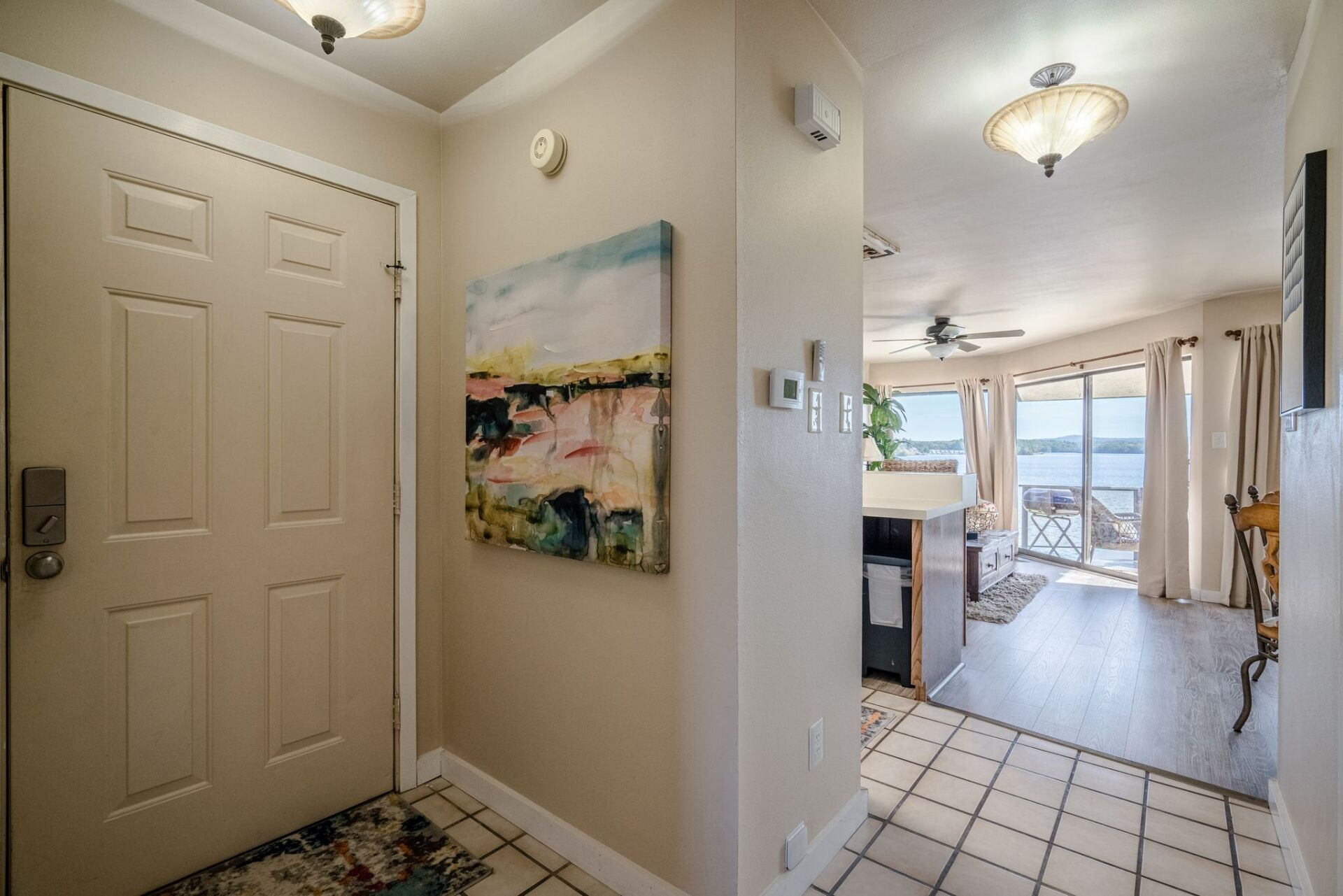 A hallway in a house with a painting on the wall.