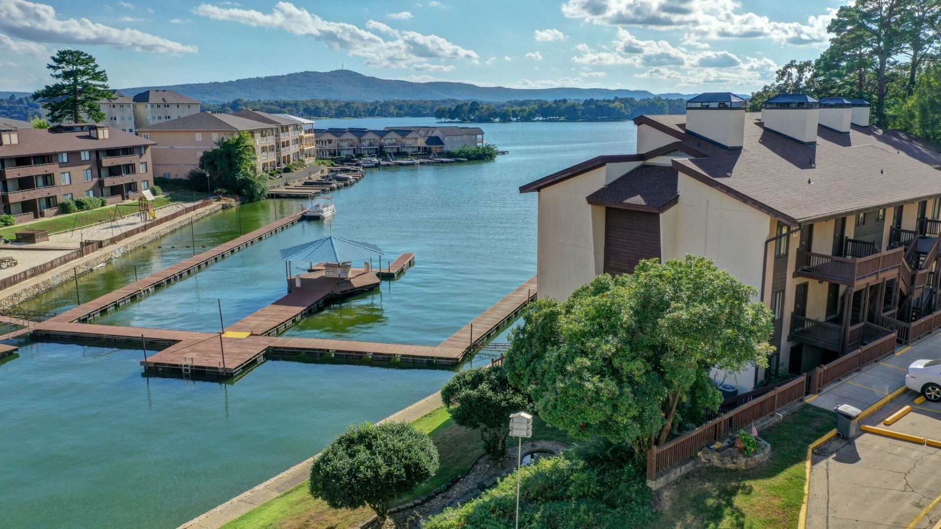 An aerial view of a building next to a body of water.