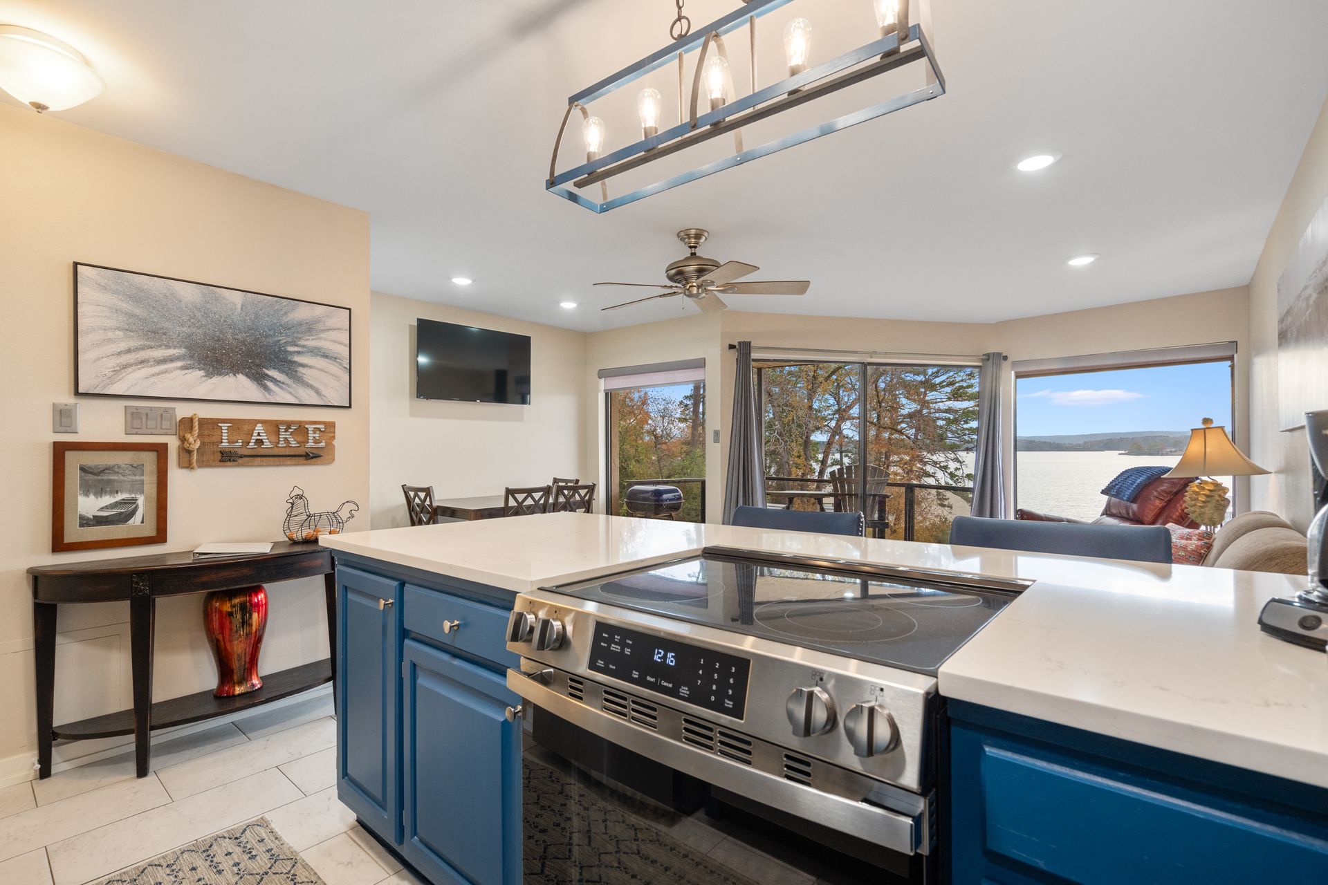 A kitchen with blue cabinets and a stove top oven