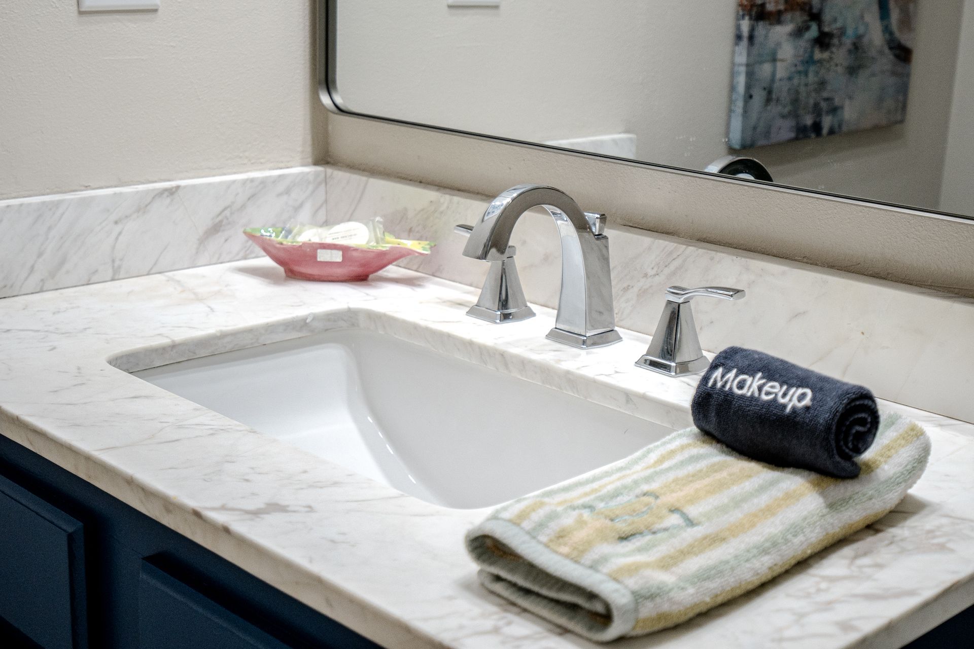 A bathroom sink with a towel on top of it and a mirror.