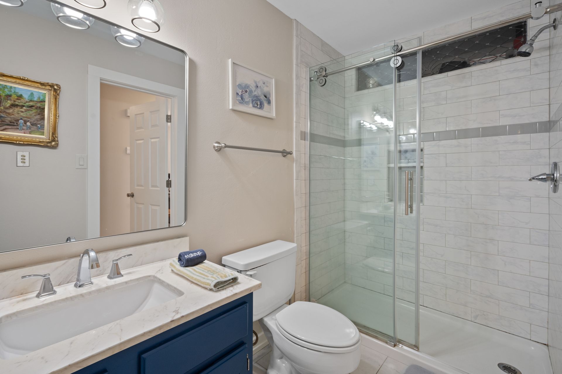 A bathroom with a toilet , sink , and shower.