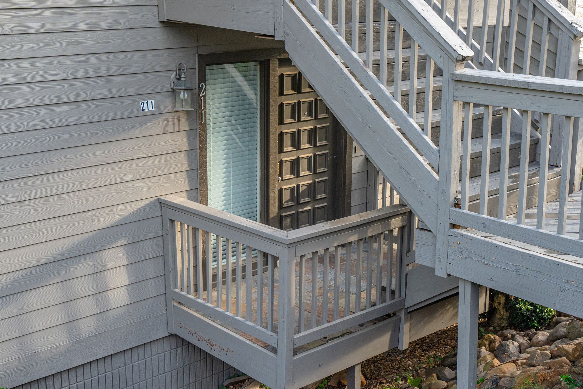 A building with a balcony and stairs leading up to it
