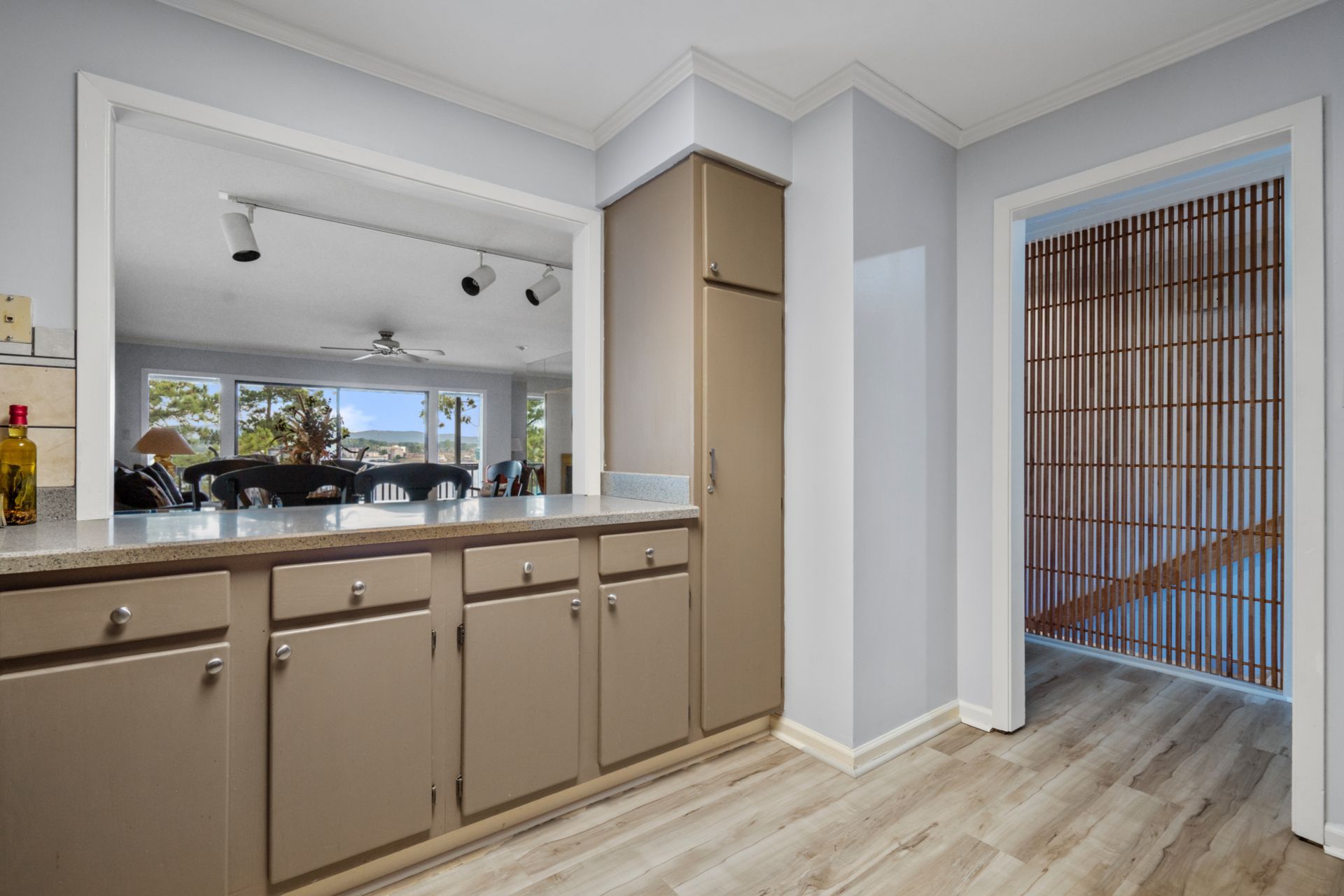 A kitchen with brown cabinets and a marble counter top.