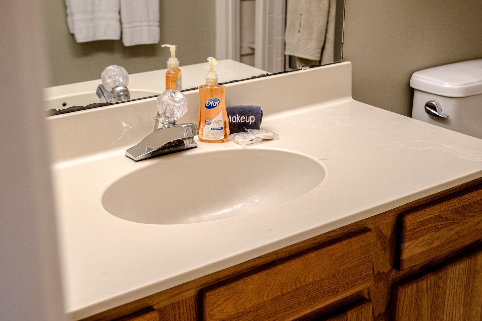 A bathroom with a sink , toilet and mirror