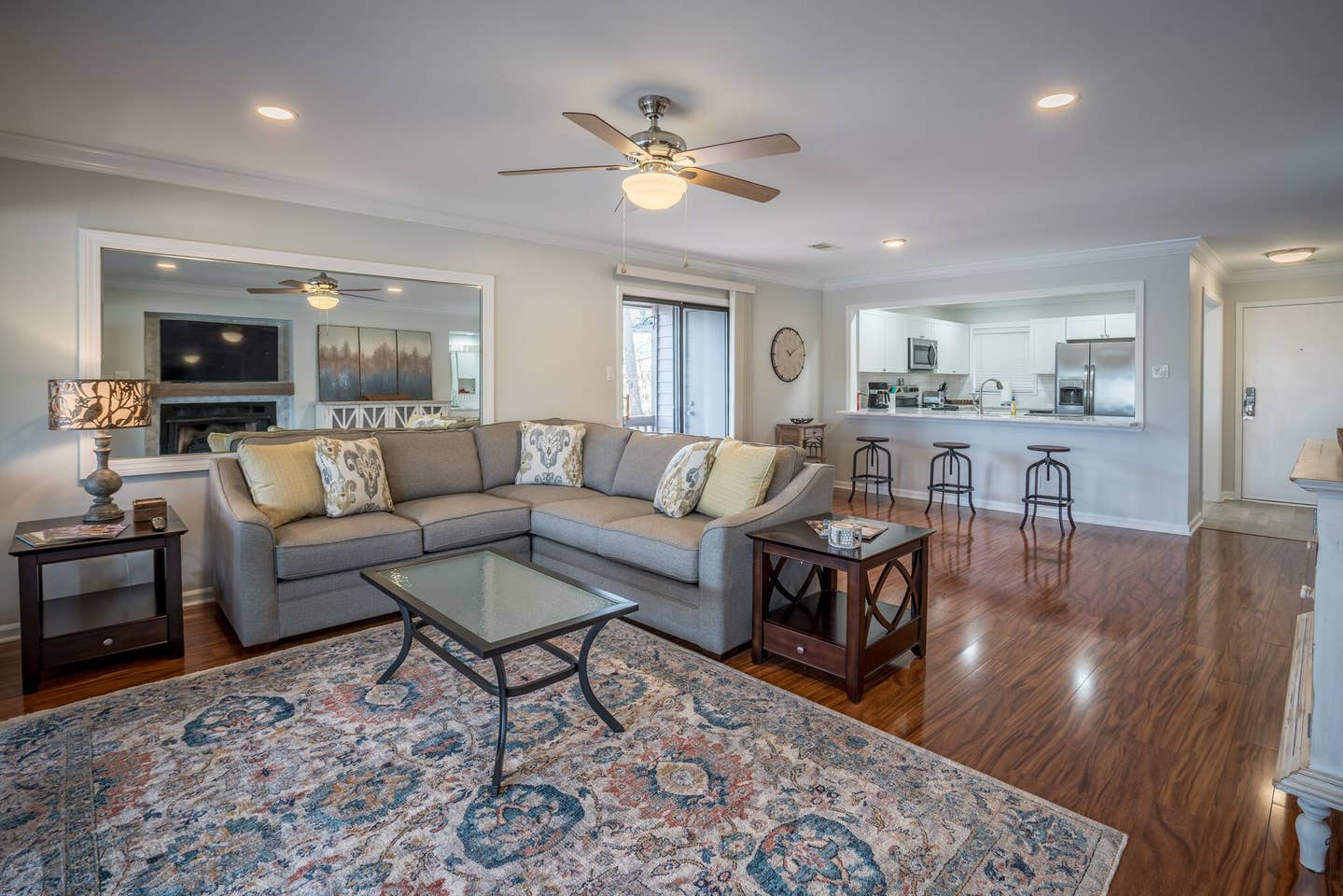 A living room filled with furniture and a ceiling fan.