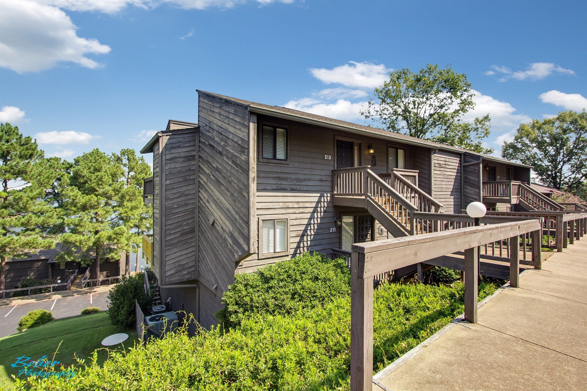 A large apartment building with stairs leading up to the second floor.