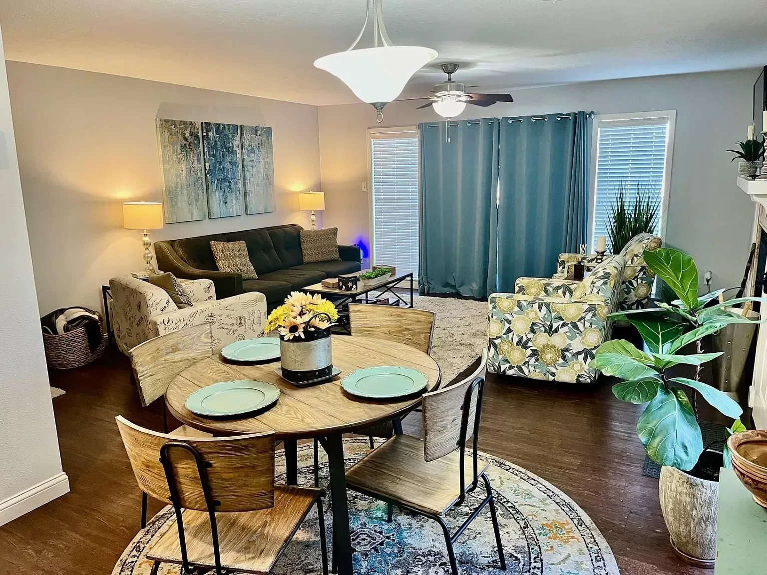 A living room with a dining table and chairs and a couch.