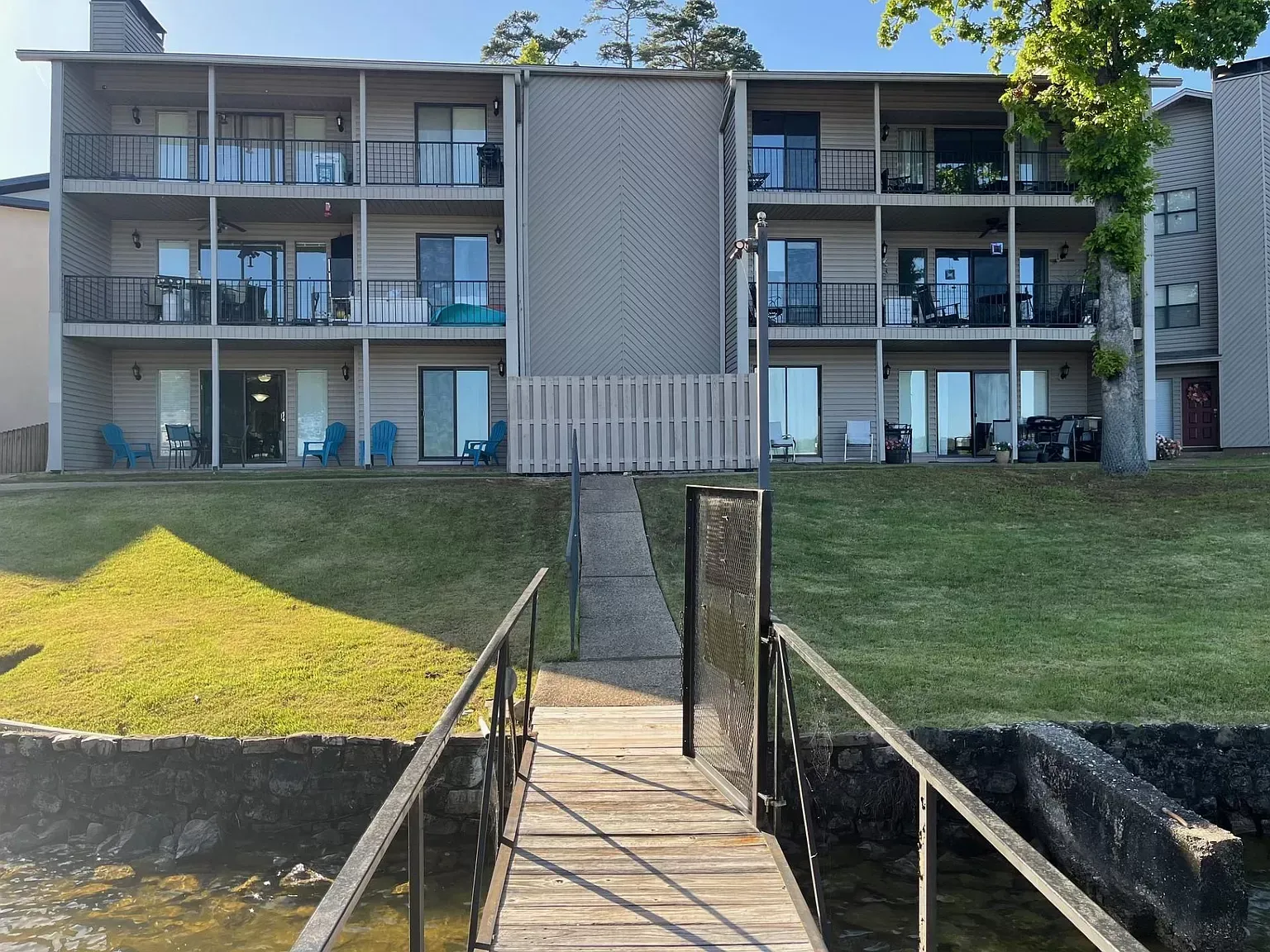 A large apartment building with a dock leading to it
