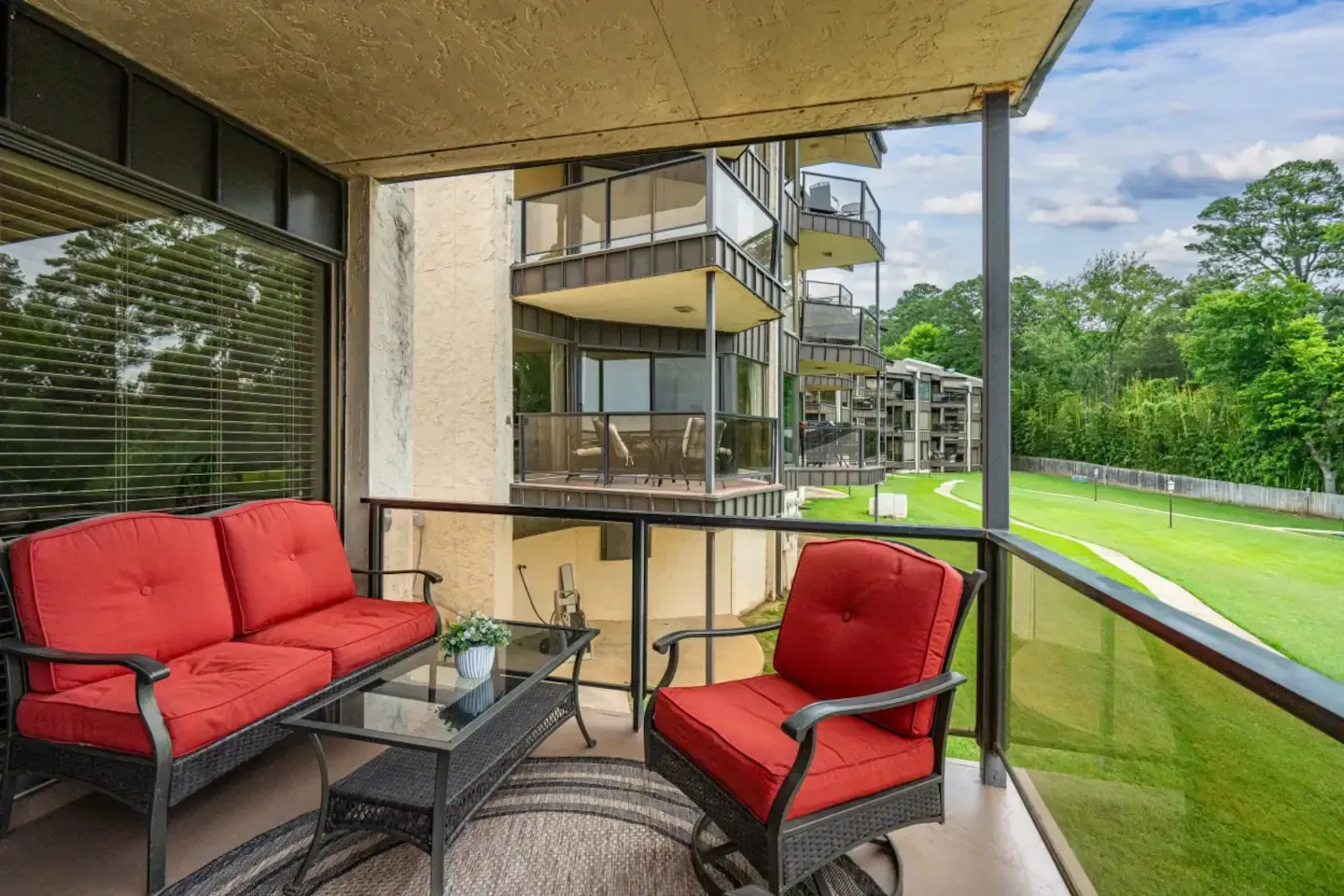 There is a balcony with a couch and chairs on it.