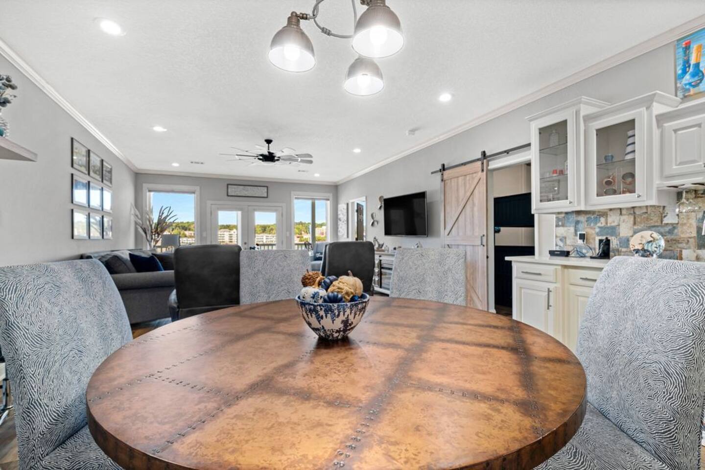 A dining room table with a bowl of food on it in a living room.