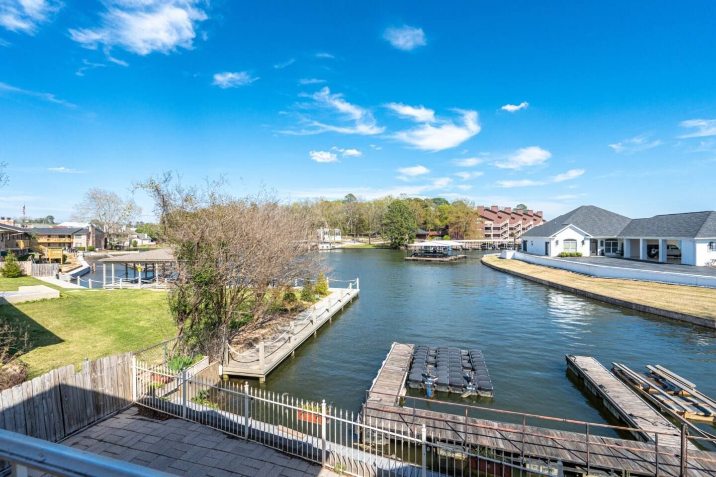 A view of a lake from a balcony of a house.