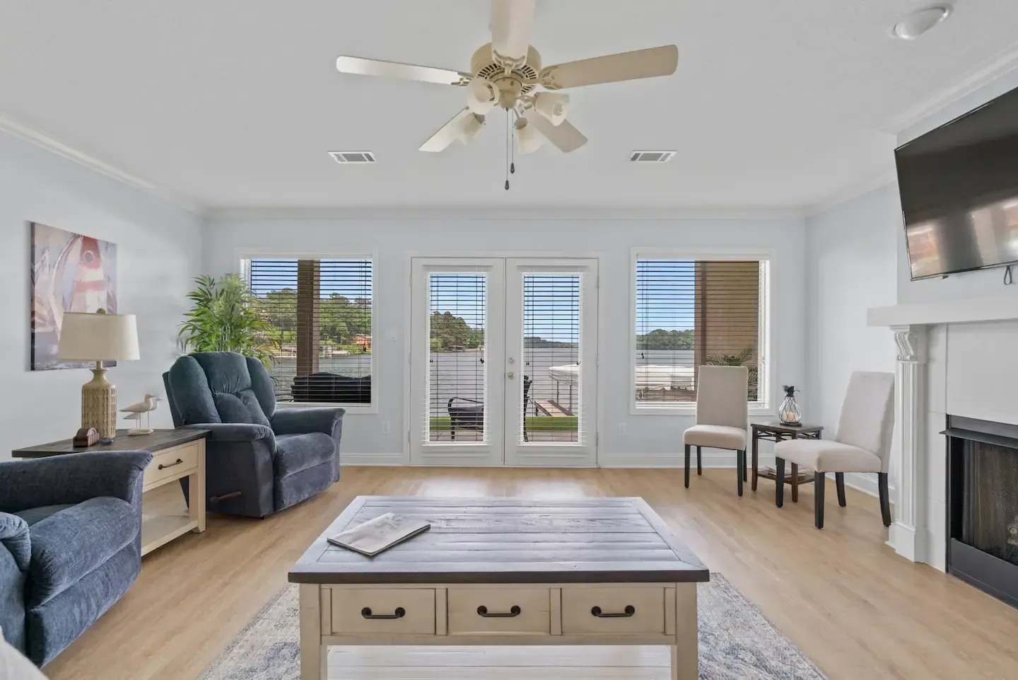 A living room filled with furniture and a ceiling fan.