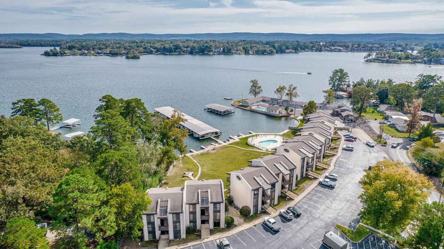 An aerial view of a lake surrounded by buildings and trees.