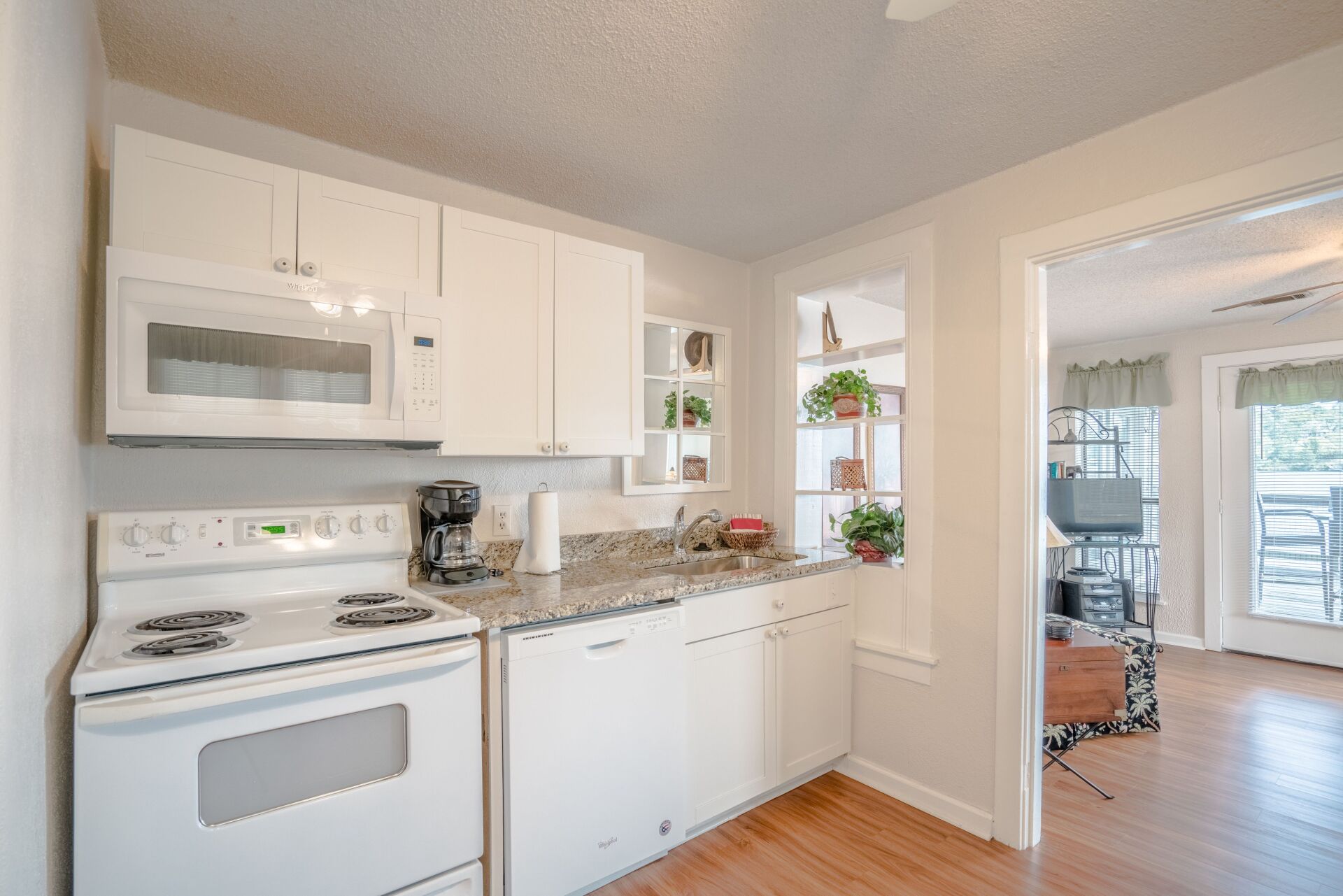 A kitchen with a stove , microwave , and dishwasher.
