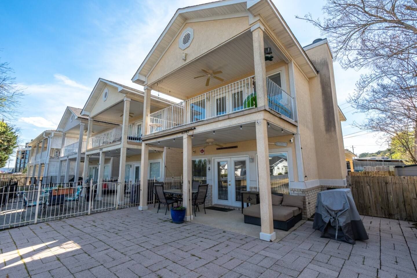 A large house with a lot of balconies and a patio.