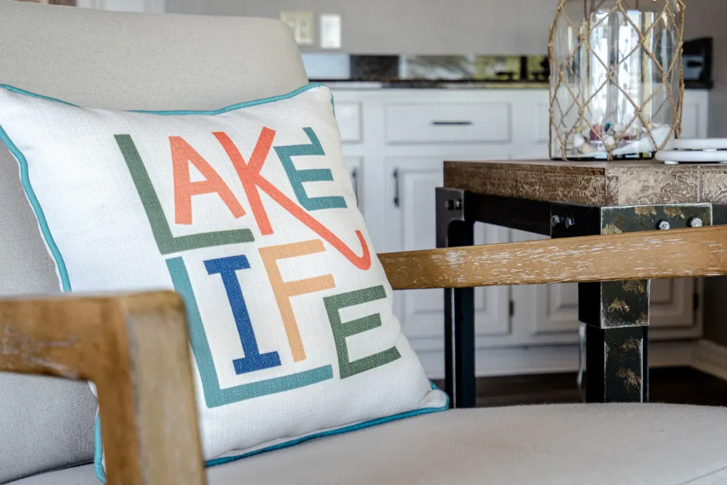 A pillow on a chair that says lake life