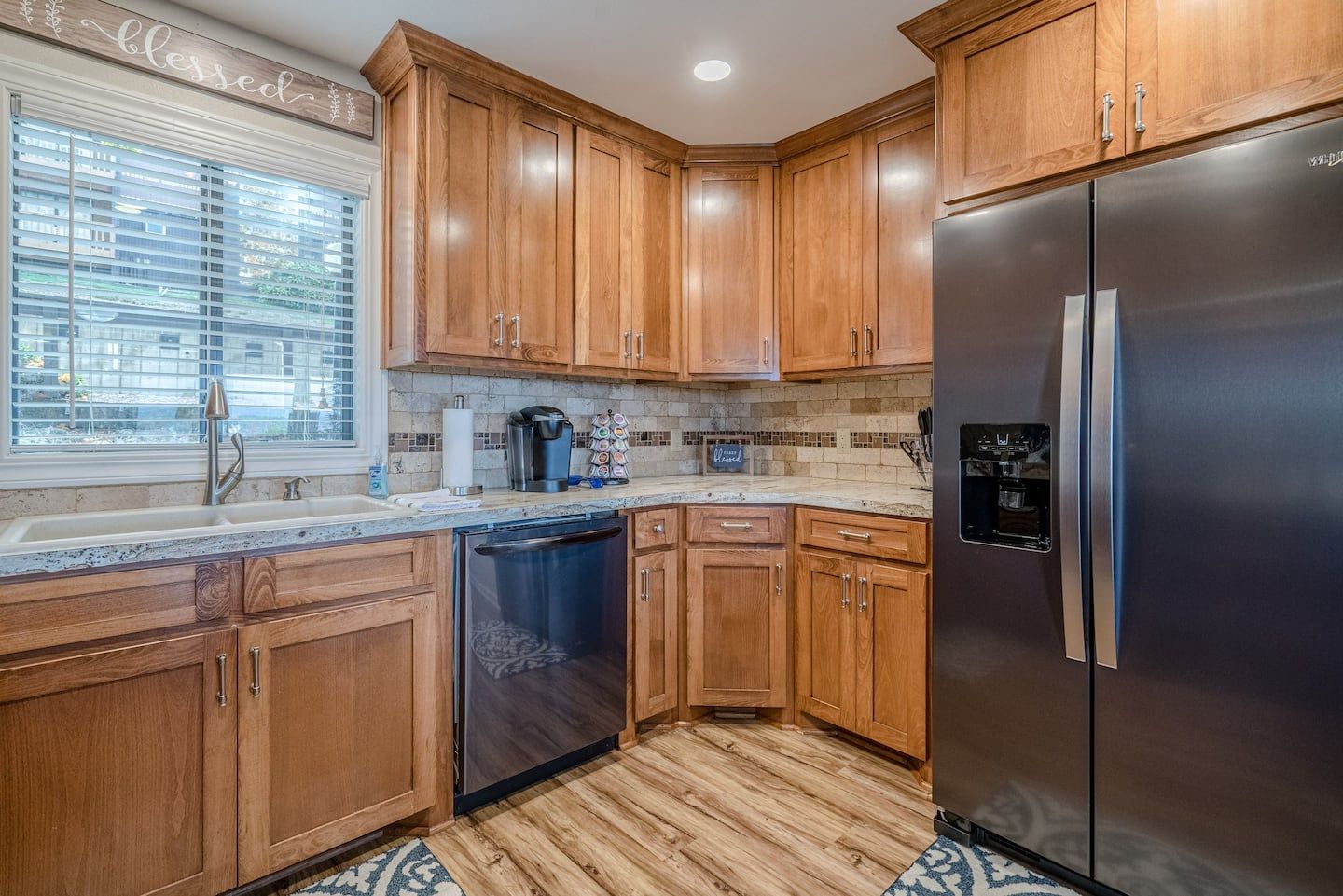 A kitchen with stainless steel appliances and wooden cabinets.