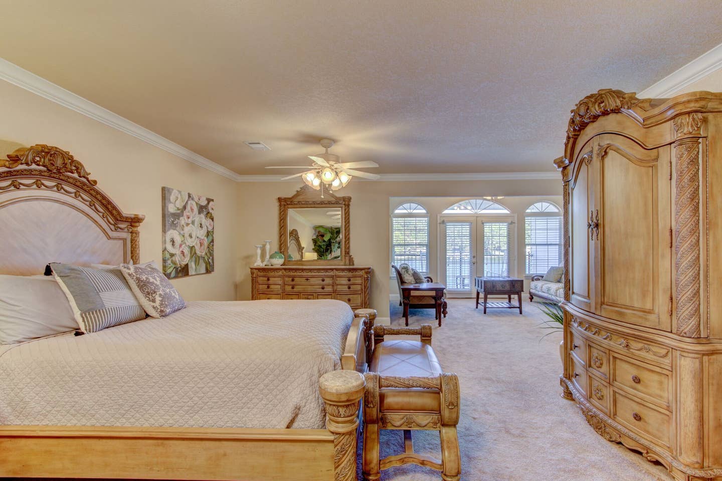 A bedroom with two beds , a dresser , a mirror and a ceiling fan.