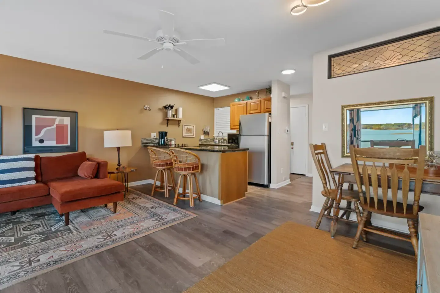 A living room filled with furniture and a ceiling fan.