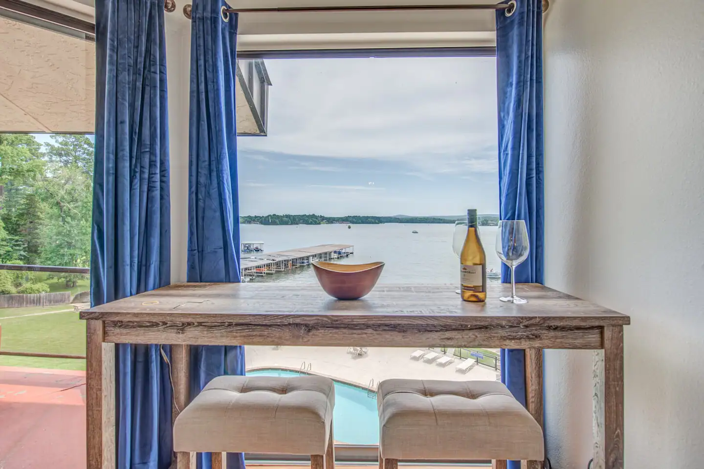 There is a table with a bottle of wine and a glass on it.