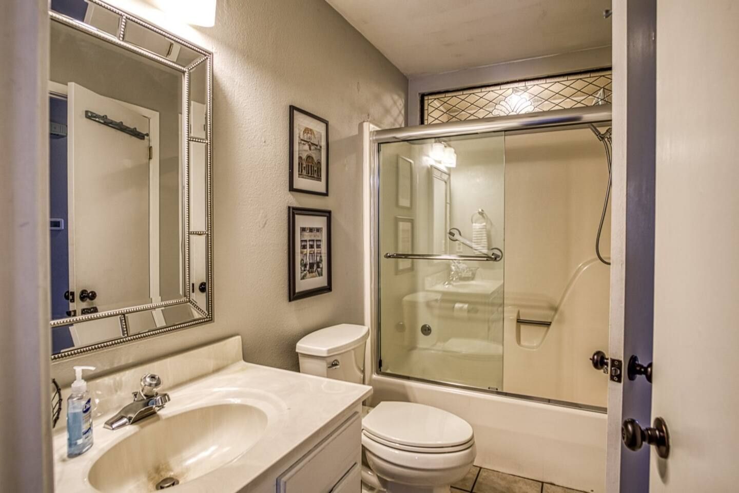 A bathroom with a toilet , sink , and shower.