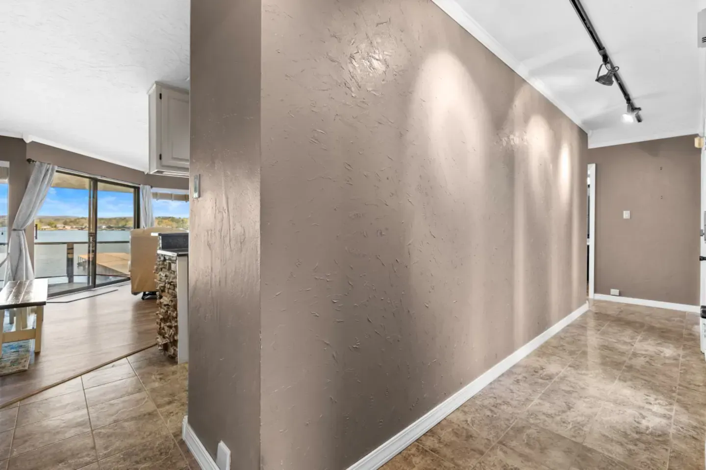 A long hallway in a house with a view of the water.