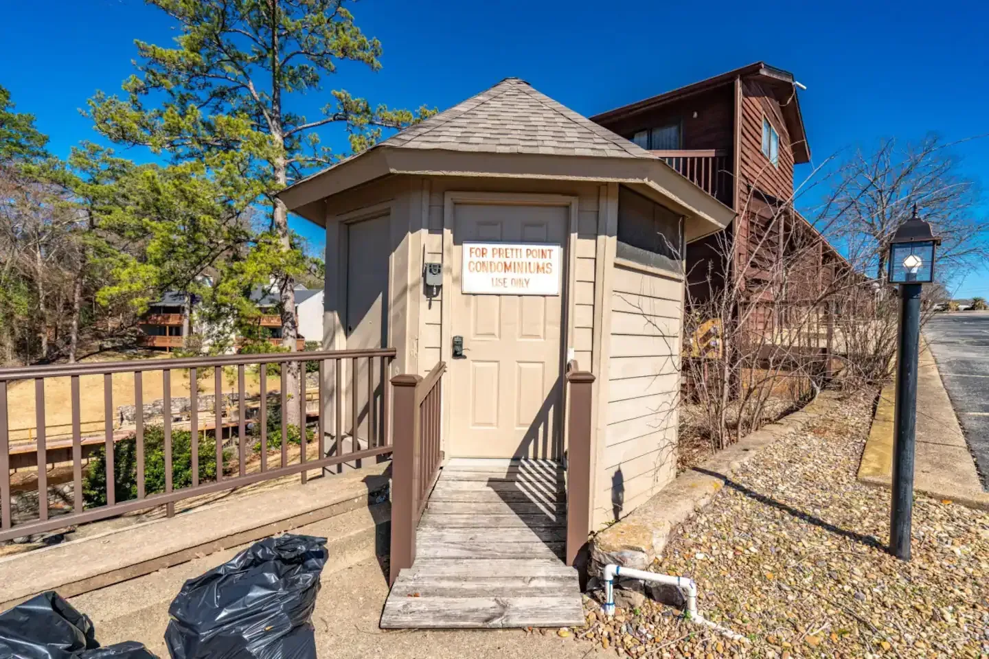 A small wooden shed with a sign on the door that says `` no dogs allowed ''.