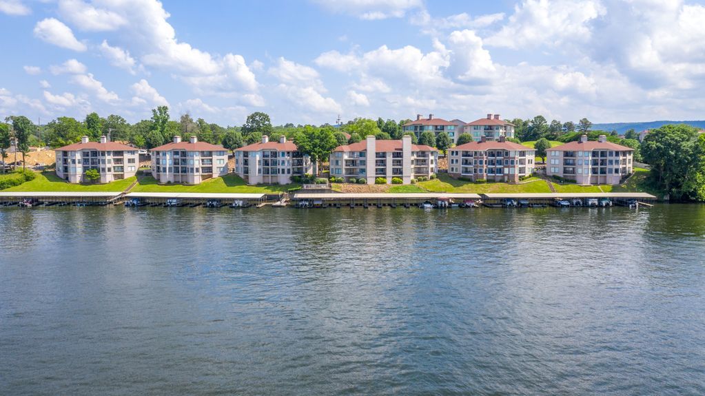 A row of buildings next to a body of water.
