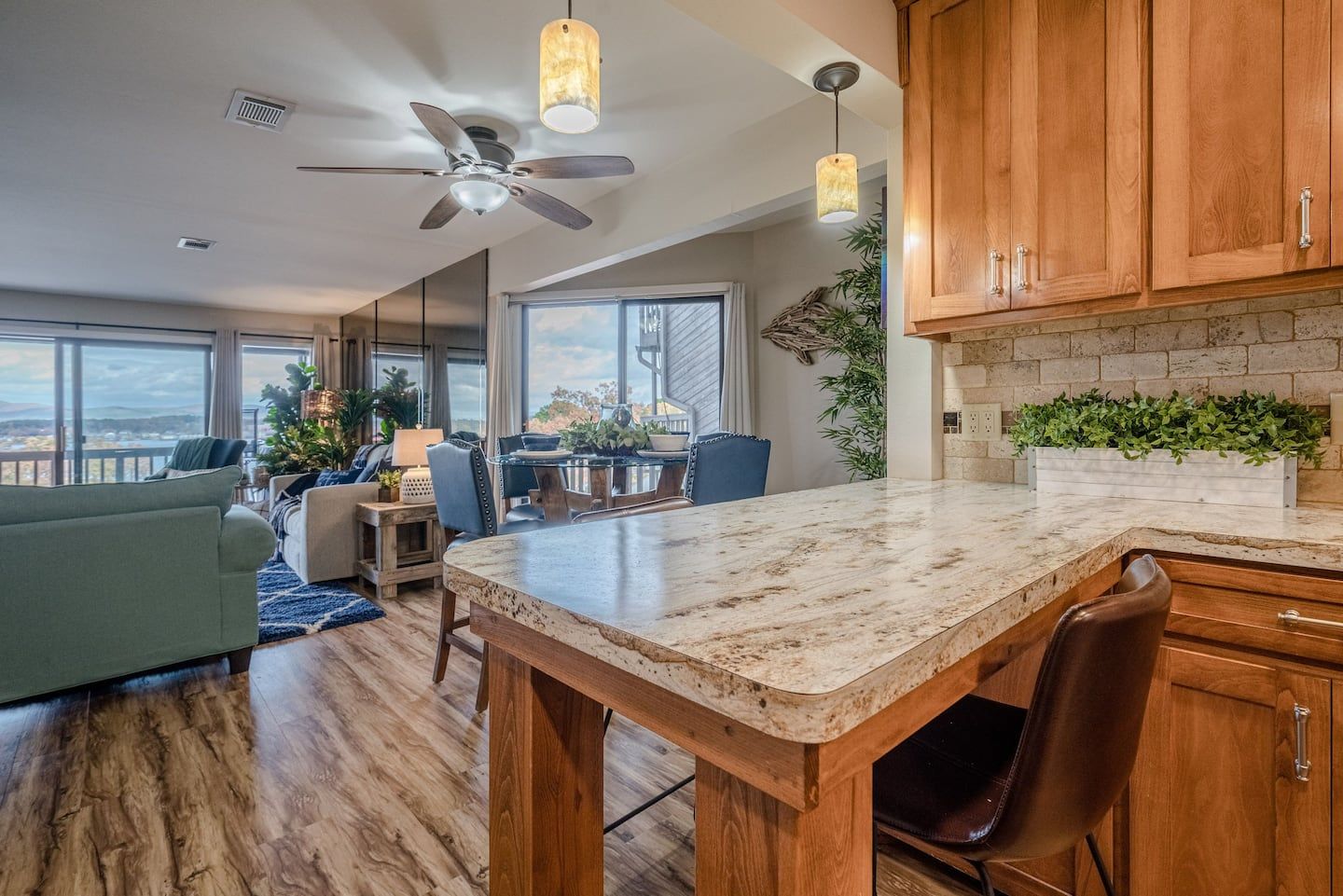 A kitchen with a large island and a ceiling fan.