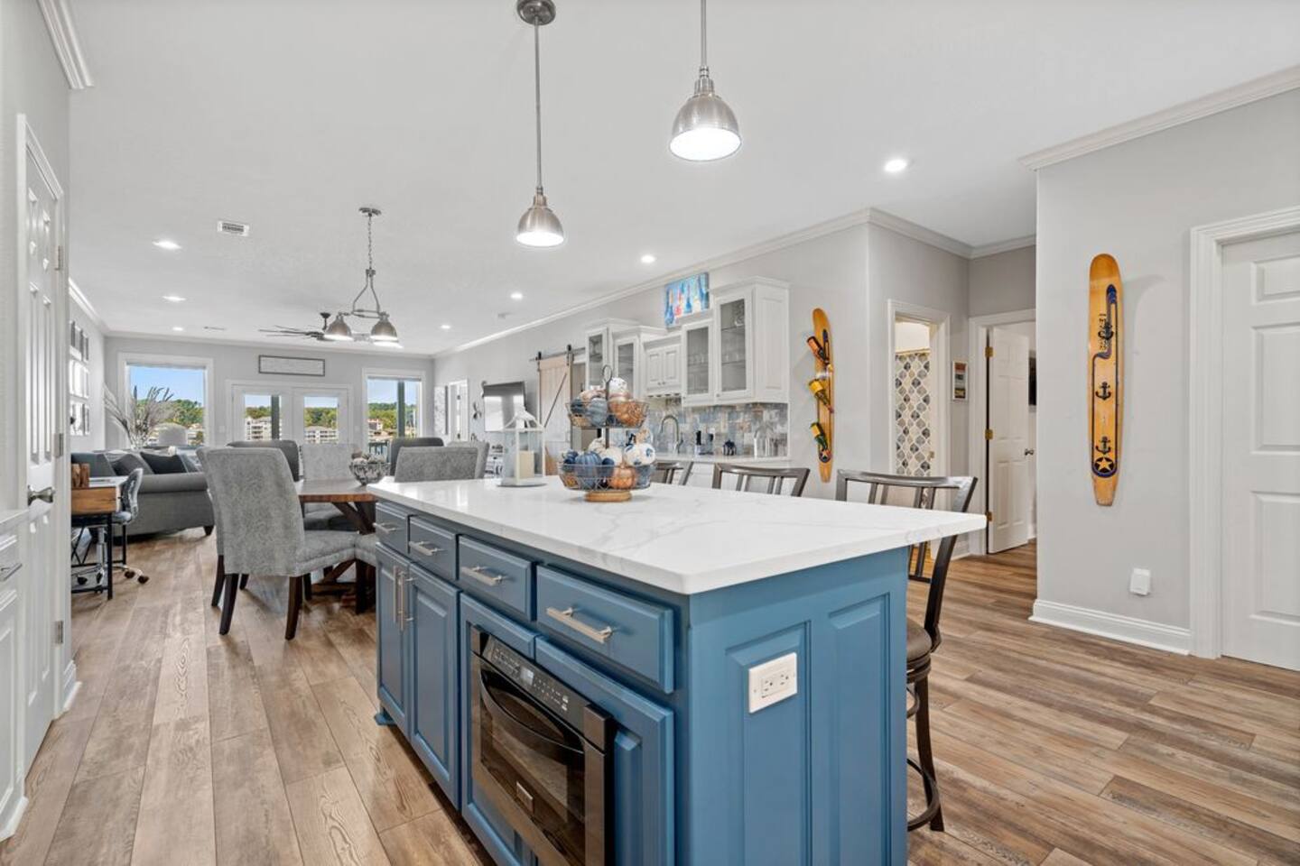 A kitchen with blue cabinets and a large island in the middle of the room.