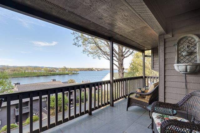 There is a balcony with a view of a lake.