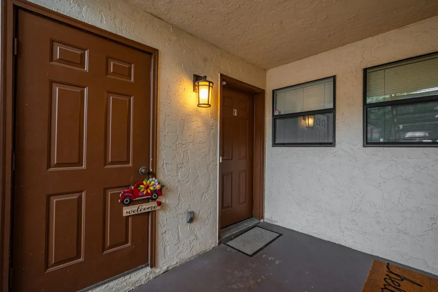 The front door of a house with a christmas decoration on it.