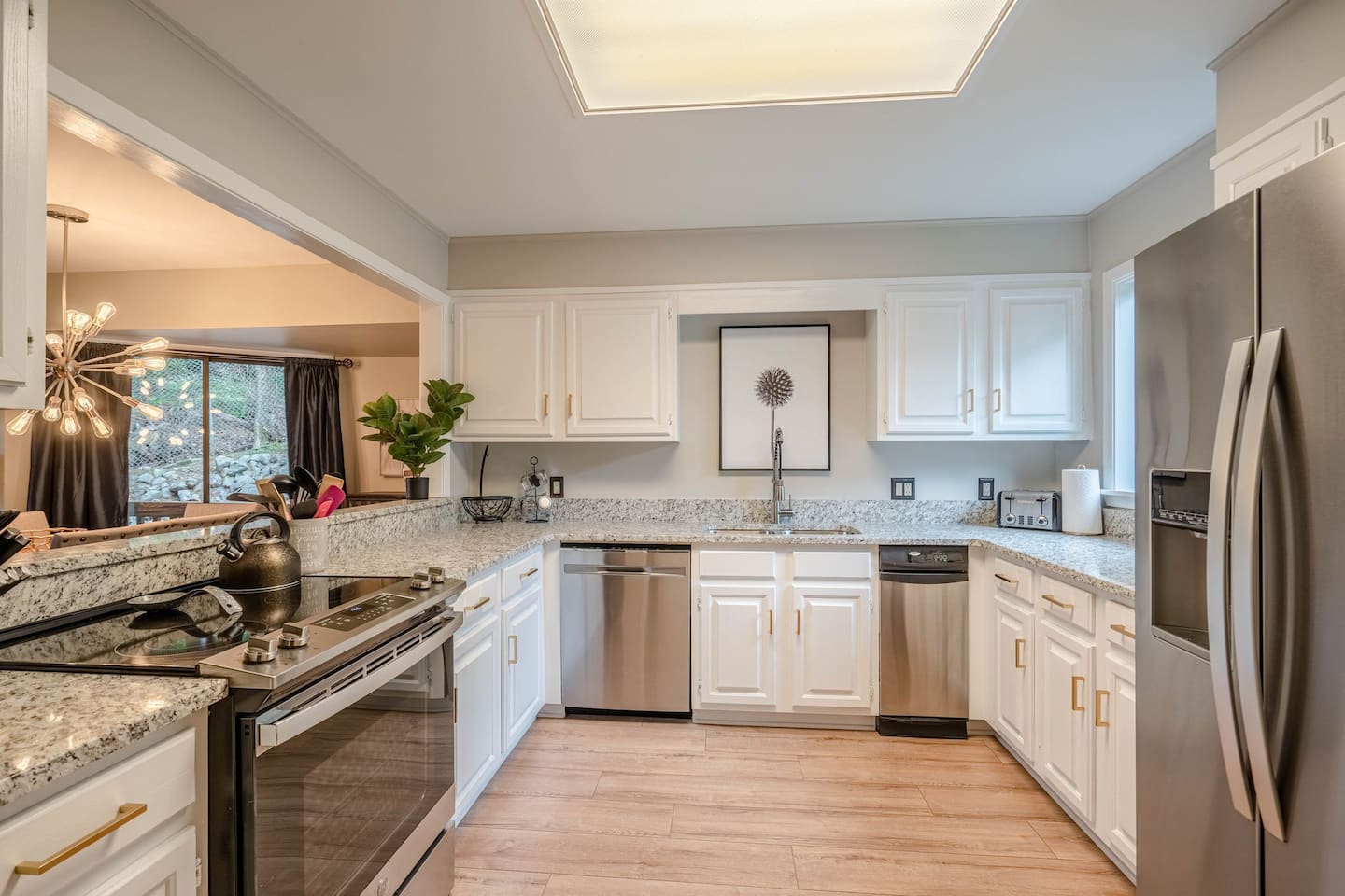 A kitchen with white cabinets and stainless steel appliances.
