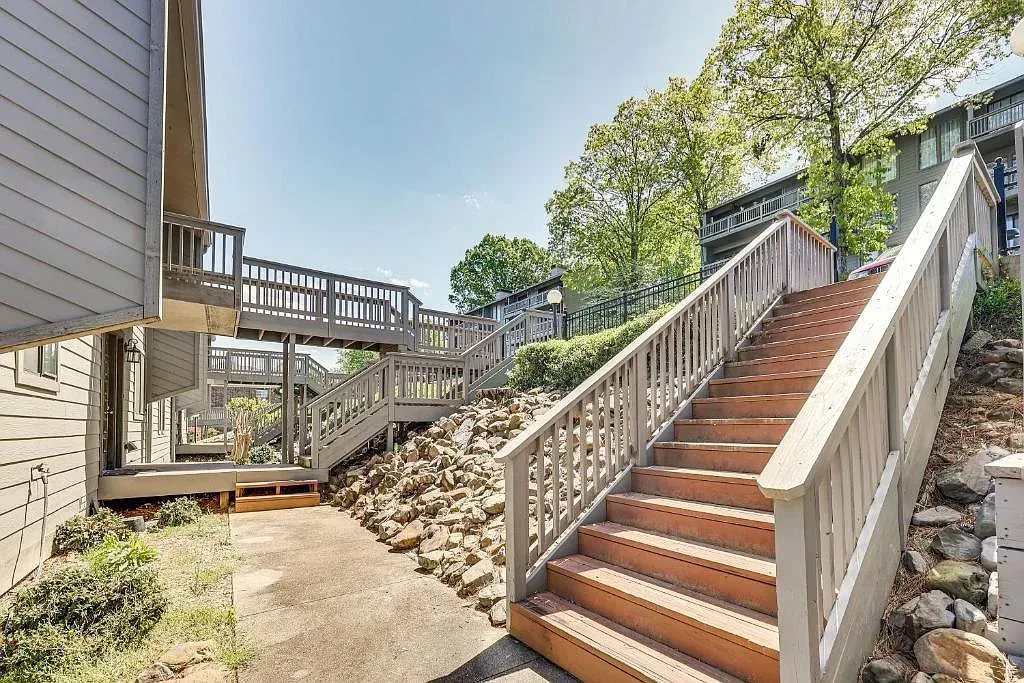 A set of wooden stairs leading up to a house.