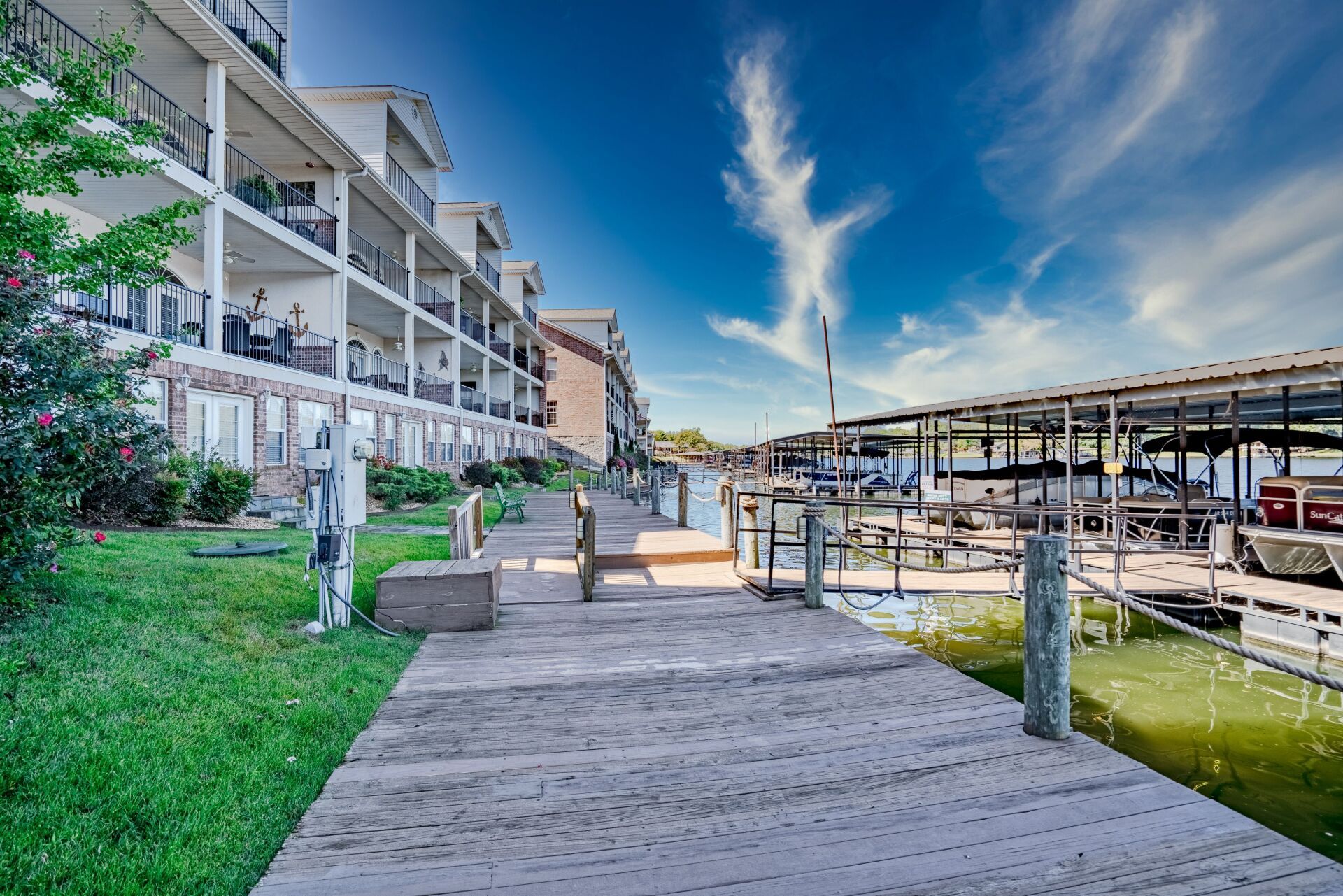 A dock with a lot of boats docked in front of a building.