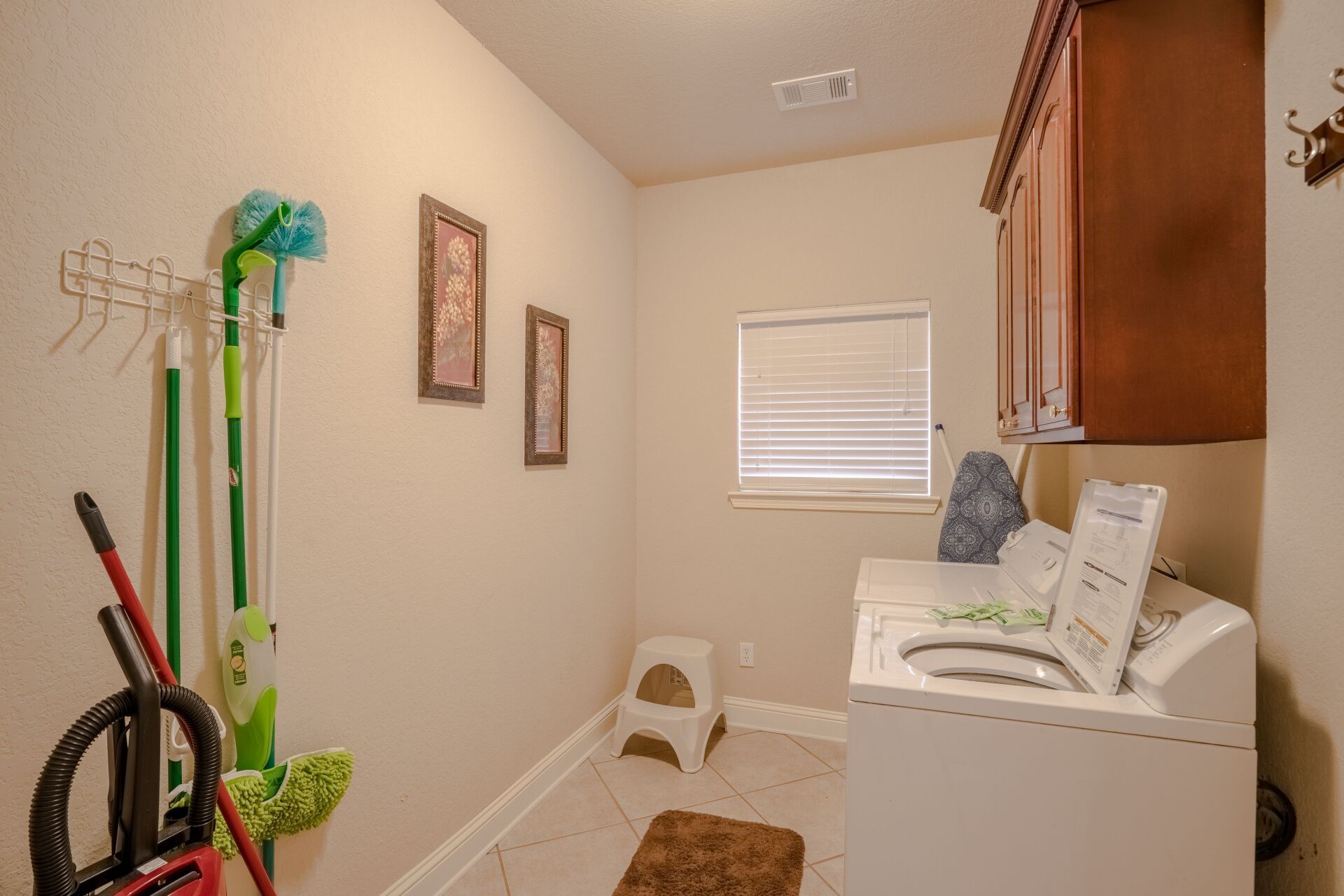 A laundry room with a washer and dryer and a window.