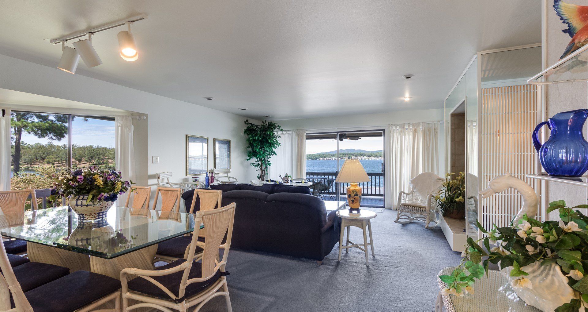 A living room with a table and chairs and a view of a lake